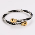Detail of twisted cable cuff bracelet in black and silver steel with gold ball ends - 5mm Bicolor Black