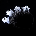 Close-up of Halloween headband with white cartoon ghosts and black tinsel on dark background - Ghost Tinsel Headband