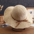Detailed close-up of handmade straw sun hat texture with brown ribbon bow decoration - One Size / Solid Color with Cord - Beige