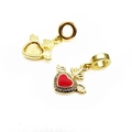 Macro view of gold winged heart charm with red enamel and pavé zircon detailing - Red Wings Heart Zirconia