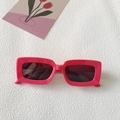 Hot pink rectangular sunglasses with dark lenses on white stone texture background - Rectangle Frame / Fuchsia
