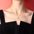 Elegant silver necklace with oval opal pendant and twisted metal edge on a model - Silver White Cat's Eye