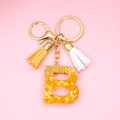 Resin initial B keychain with orange gold foil flakes and colorful suede tassels - Letter B