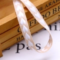 Macro view of 10mm beige cotton ribbon with white woven heart pattern for gift wrapping - 10mm / White