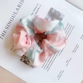 Pink and green tie-dye organza scrunchie hair tie on minimalist magazine background - Phantom Pink
