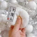 Juguete antiestrés con forma de panecillo al vapor fluido en envase transparente - Pan al Vapor Fluido