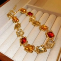 Detail view of vintage gold necklace with amber and red crystals in jewelry box - 32# Necklace - Gold - Square