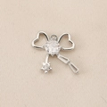Macro detail of silver bow pendant with embedded white zircon and star elements - PJ0177-Silver Double Heart Star Tassel