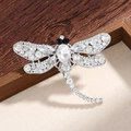 Silver dragonfly brooch with sparkling clear crystals and black rhinestone eyes - White