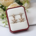 Starfish tassel earrings in gold finish with pearls displayed in a red jewelry box - Gold Pearl Starfish