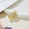 Macro shot of a gold sunflower pendant featuring clear zircon petals and center stone - White