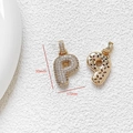 Macro view of gold P-letter pendant with zircon inlay and 30mm height dimension - Letter P