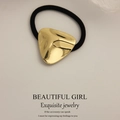 Minimalist gold triangular metal hair tie with black elastic band on white background - Glossy Embossed Triangle Gold