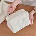 White quilted shell pattern makeup bag with silver ring zipper for travel storage - Pillow Shell Style