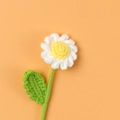 Handmade crochet white daisy flower with green leaf on a vibrant orange background - Daisy / White