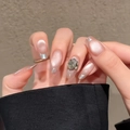 Detail of nude gradient press-on nails with silver French tips and a large rhinestone - By1714 Auspicious Sounds / Glue Type