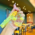Yellow Mickey shaped liquid keychain with sequins and daisy patterned strap - Yellow Luminous Mickey Head