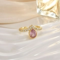 Macro shot of gold ring featuring teardrop pink stone and crystal pavé on silk background - Large Pink Pear Gem Pave Style (JZ0148)
