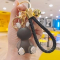 Detail of dark gray matte bunny keychain with rhinestones and golden bell on leather strap - Rabbit Shape (Dian Zhuan Guo Dong Tu) / Gray