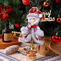 Detailed view of snowman ornament with red plaid fabric and golden bells on a festive tree - Snowman