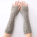 Detailed view of gray knit arm warmers with a thick cable pattern texture and fingerless design - Light Gray