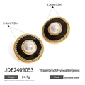 Detailed macro view of retro button earrings with black enamel and white pearl inlay - Round Pearl Black Enamel Button