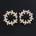 Luxurious C-shaped gold-plated hoop earrings with sparkling zircon floral patterns on black background - White