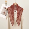 Classic American paisley silk scarf in terracotta red hanging on a wooden hanger - Terracotta