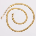 Close-up of golden flat snake chain necklace with lobster clasp and adjustable link chain - Gold Color Wave Textured
