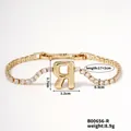 Elegant gold-tone bracelet featuring a cubic zirconia chain and letter R pendant charm - Letter R