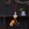 Detailed view of red cord keychain with peanut and persimmon charms for good luck - Good Things Happen Phone Chain Type 3