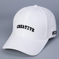 Macro shot of white baseball cap featuring black 'CREATIVE' letter embroidery and stitch detail - M (56-58cm) / White