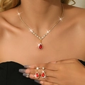 Macro detail of red teardrop gemstone necklace and earrings set with gold plating - 2-Piece Set / Gold Red