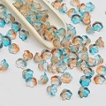 Macro shot of lily of the valley glass flower beads with blue and amber gradient - Lily of the Valley 25# Dawn Blue Amber 7x12mm