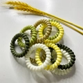 Macro detail of elastic spiral hair ties in assorted green and white natural colors - Yellow Set of 10