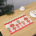 Festive Christmas table placemat with red and green ornament design on a wooden dining table - Balloon Style