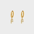 Detailed close-up of golden stainless steel earring with F-letter charm and white zircons - Letter F