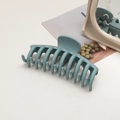 Detailed view of large matte blue hair claw clip with frosted texture and wide teeth - Keel / Milky Blue