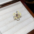 Macro shot of silver floral ring with yellow enamel petals and purple gemstone detail - Ring - Yellow