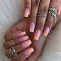 Gradient pink and orange press-on nails in long coffin shape with pink glitter accents - Yellow Jelly Glue + Nail File