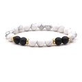 Macro detail of elastic beaded bracelet with white turquoise and matte black agate stones - Howlite
