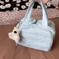 Quilted light blue puffy cosmetic bag with a cute white plush bear charm and top handle - Light Blue