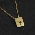 Macro view of gold 18K stainless steel Capricorn zodiac rectangular pendant necklace - Capricorn