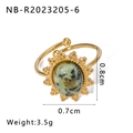 Macro detail of vintage gold plated ring featuring green stone and sunburst engraving - Sunflower Green Black Pattern Stone Style (NB-R2023205-6)
