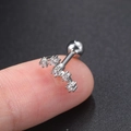 Detailed macro view of silver steel helix stud with five sparkling zircons on a fingertip - Big Dipper Silver - 1PC