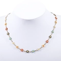 Golden stainless steel necklace with colorful enamel daisy pendants on white bust stand - Gold + Multi-color