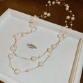 Macro detail of elegant double-layer pearl necklace with gold chain in a jewelry box - Necklace-White