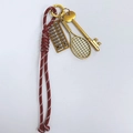 Red and white woven paracord keychain with golden abacus and tennis racket charms - Burgundy