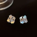 Macro shot of shell petal flower earrings with zircon on reflective black background - Silver (Silver Pin)