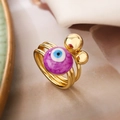 Dettaglio dell'anello occhio di Allah dorato multistrato con una perla viola marmorizzata - Aperto Regolabile / Occhio del diavolo viola